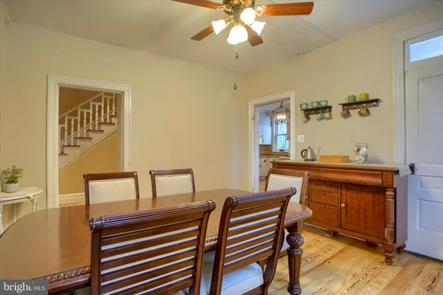 a view of hall way with furniture and chandelier