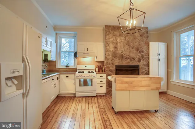 a kitchen with a stove a sink and a refrigerator