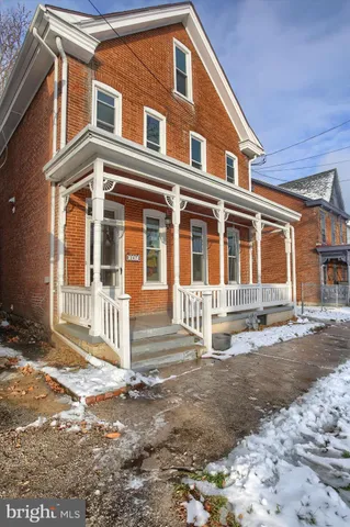 a front view of a house with a street