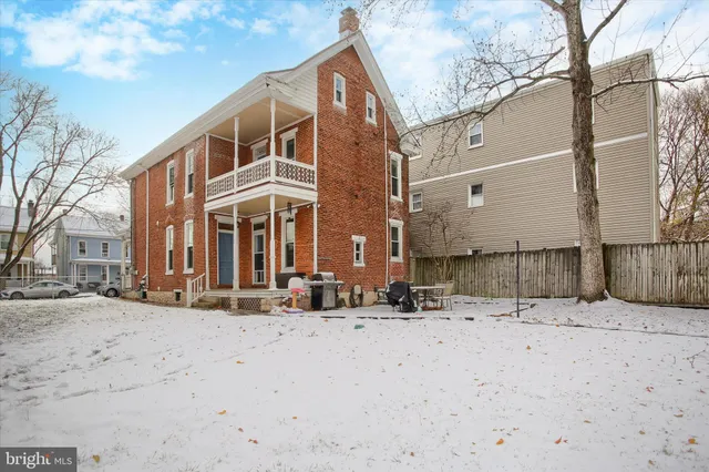 a view of a house with snow on the road