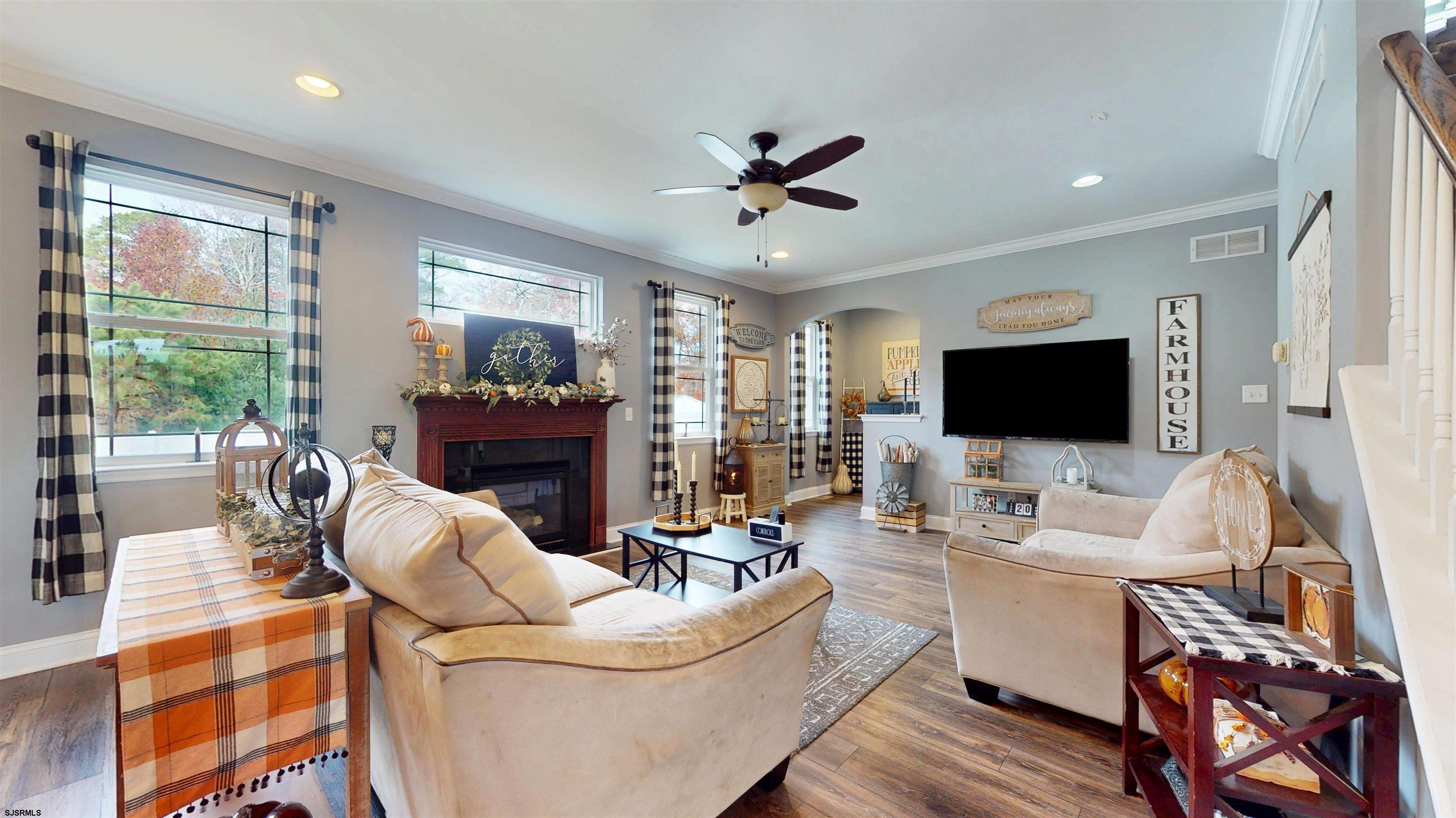 7 Fairfax Road Egg Harbor Township, NJ 08234 - Photo 11 of 34 a living room with furniture a flat screen tv and a large window