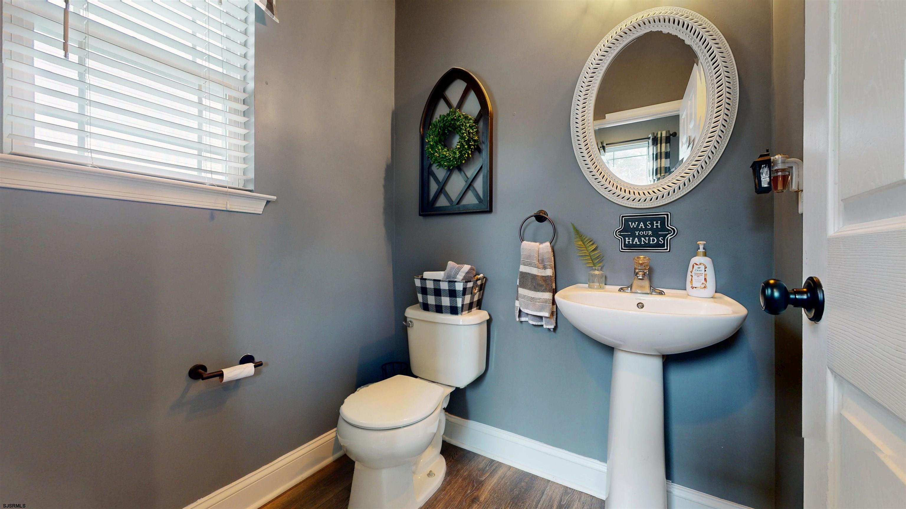 7 Fairfax Road Egg Harbor Township, NJ 08234 - Photo 13 of 34 a bathroom with a toilet sink and mirror