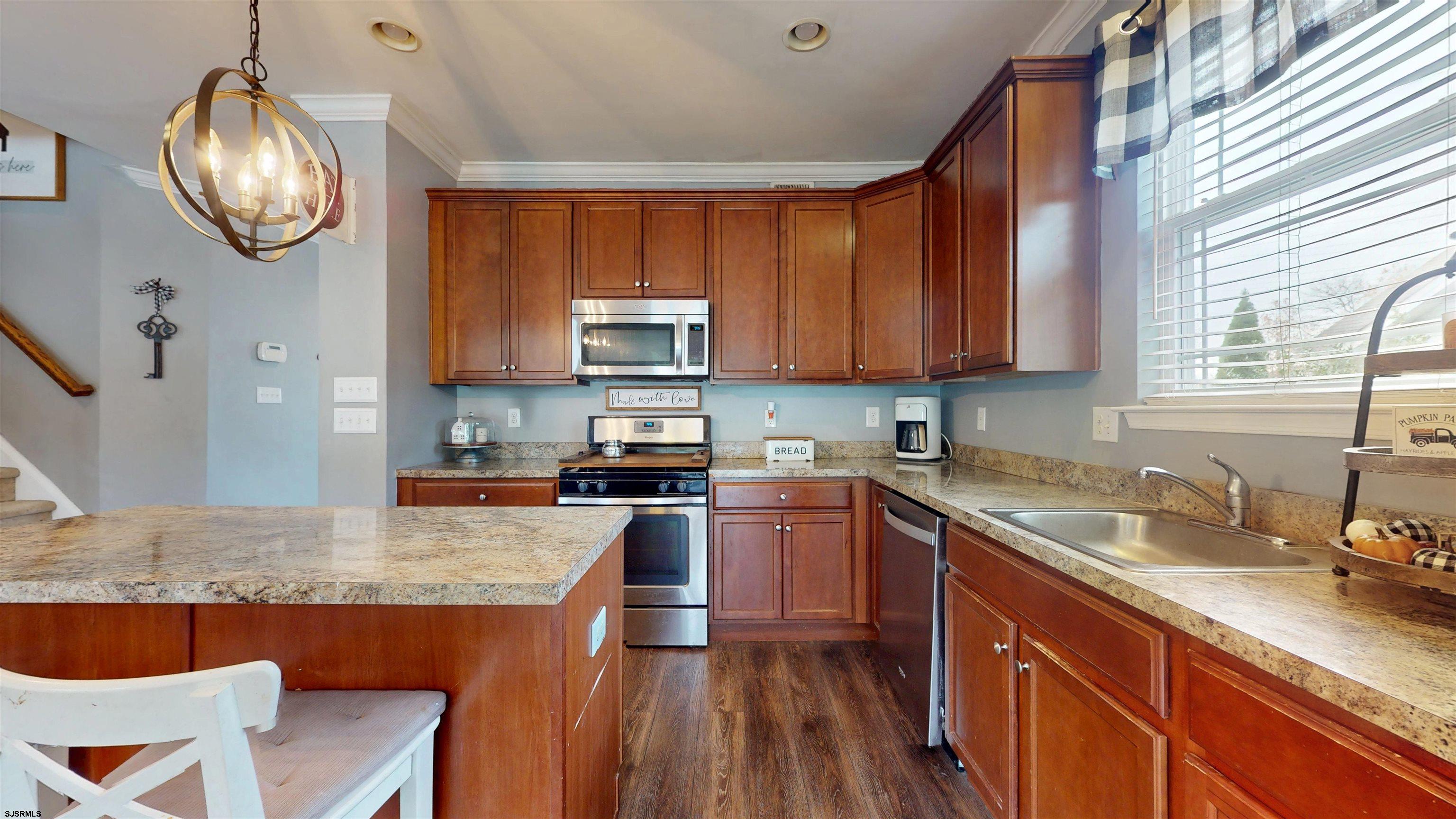7 Fairfax Road Egg Harbor Township, NJ 08234 - Photo 8 of 34 a kitchen with granite countertop wooden cabinets a sink and dishwasher
