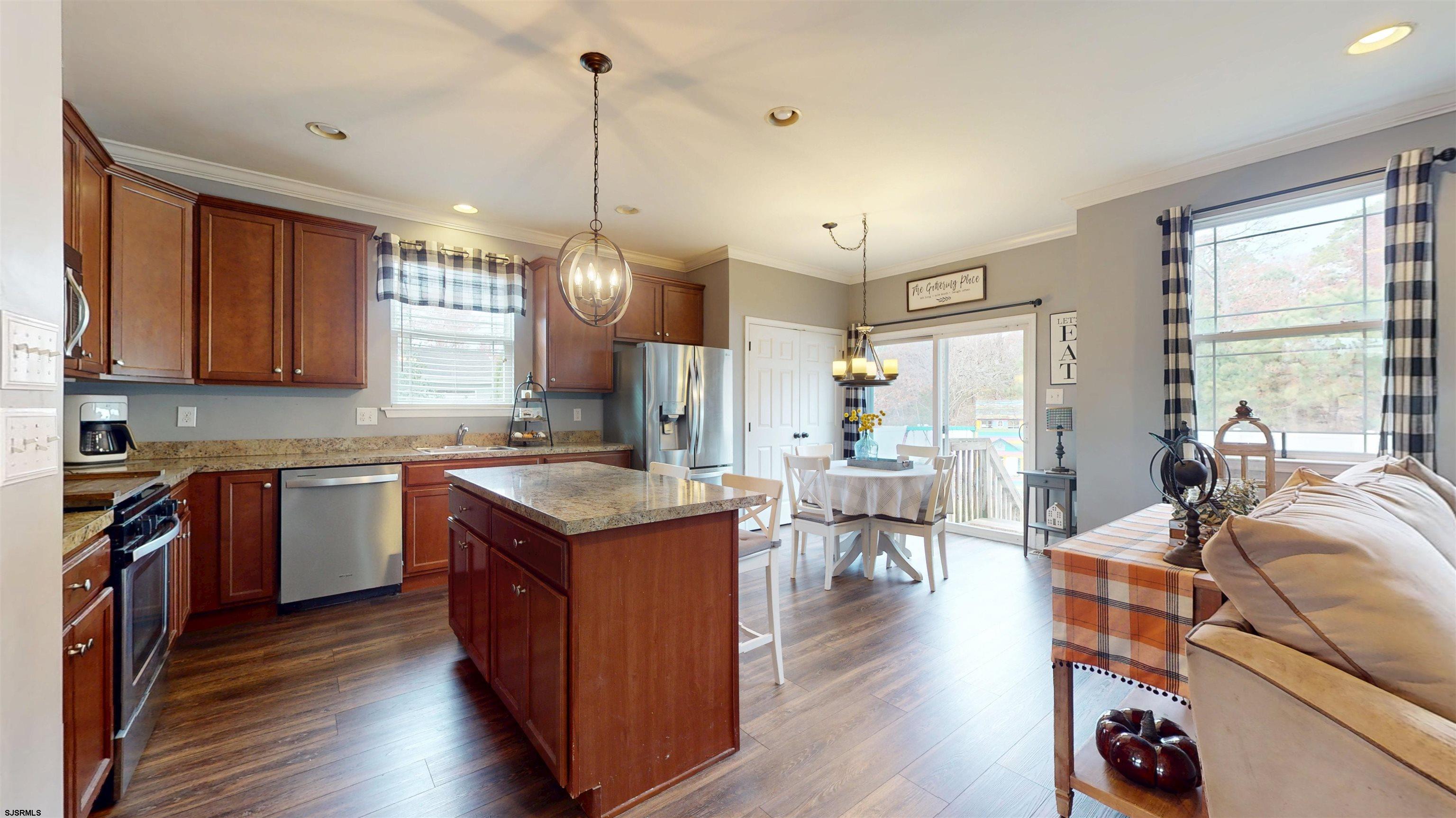 7 Fairfax Road Egg Harbor Township, NJ 08234 - Photo 10 of 34 a open kitchen with stainless steel appliances granite countertop a stove top oven a refrigerator a sink and dishwasher with wooden floor
