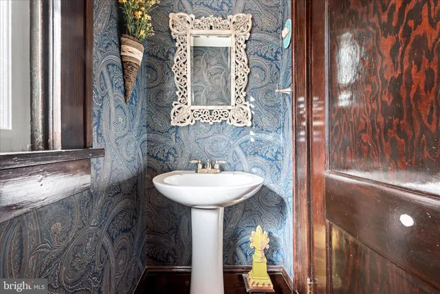 a living room with furniture a window and a chandelier