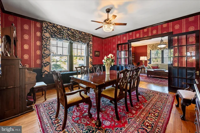 a living room with furniture fireplace and a large window