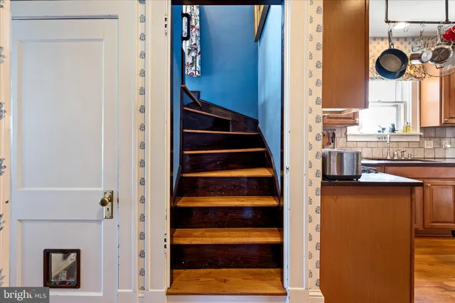 a living room with furniture and a book shelf