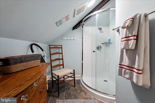 a view of a patio with table and chairs with wooden floor and fence