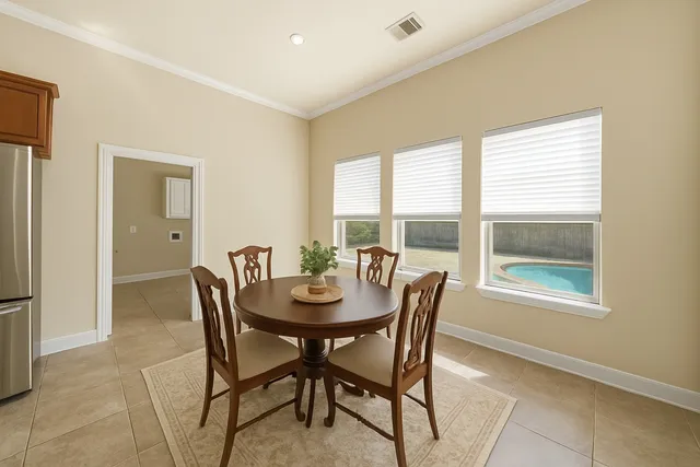 a dining room with furniture and window
