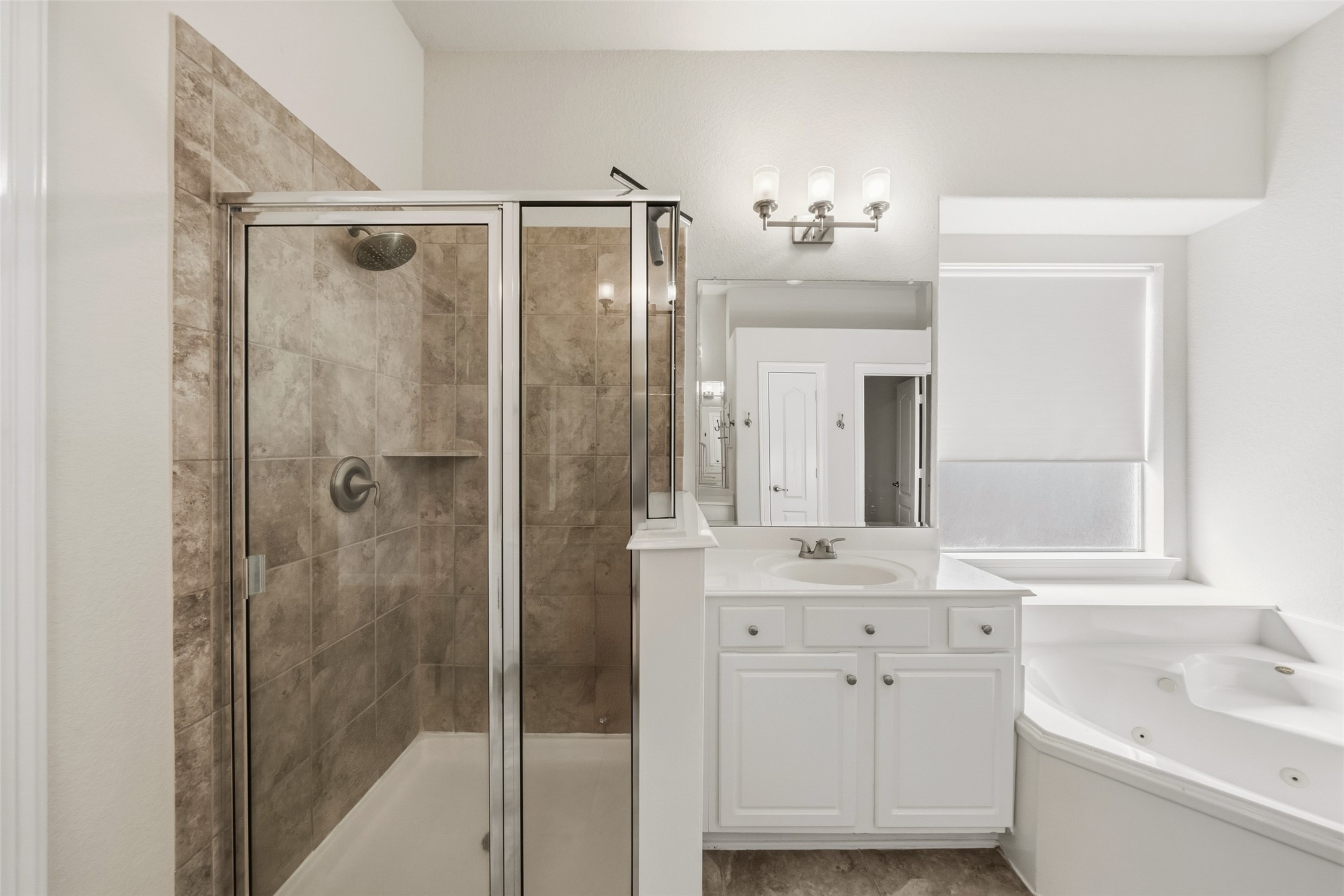 25802 Northcrest Drive Spring, TX 77389 - Photo 16 of 28 a bathroom with a shower sink and mirror