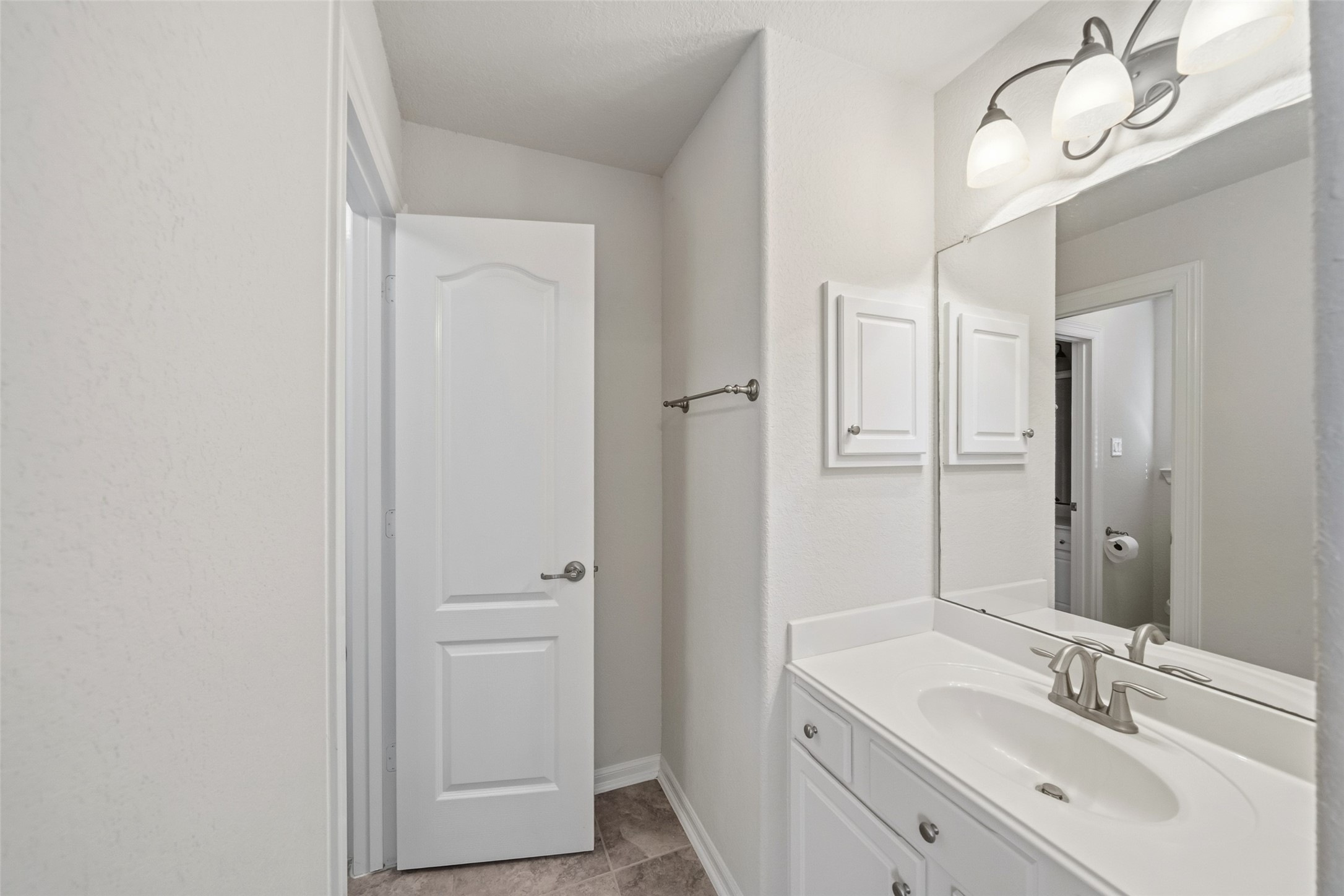 25802 Northcrest Drive Spring, TX 77389 - Photo 23 of 28 a bathroom with a double vanity sink a mirror and a shower
