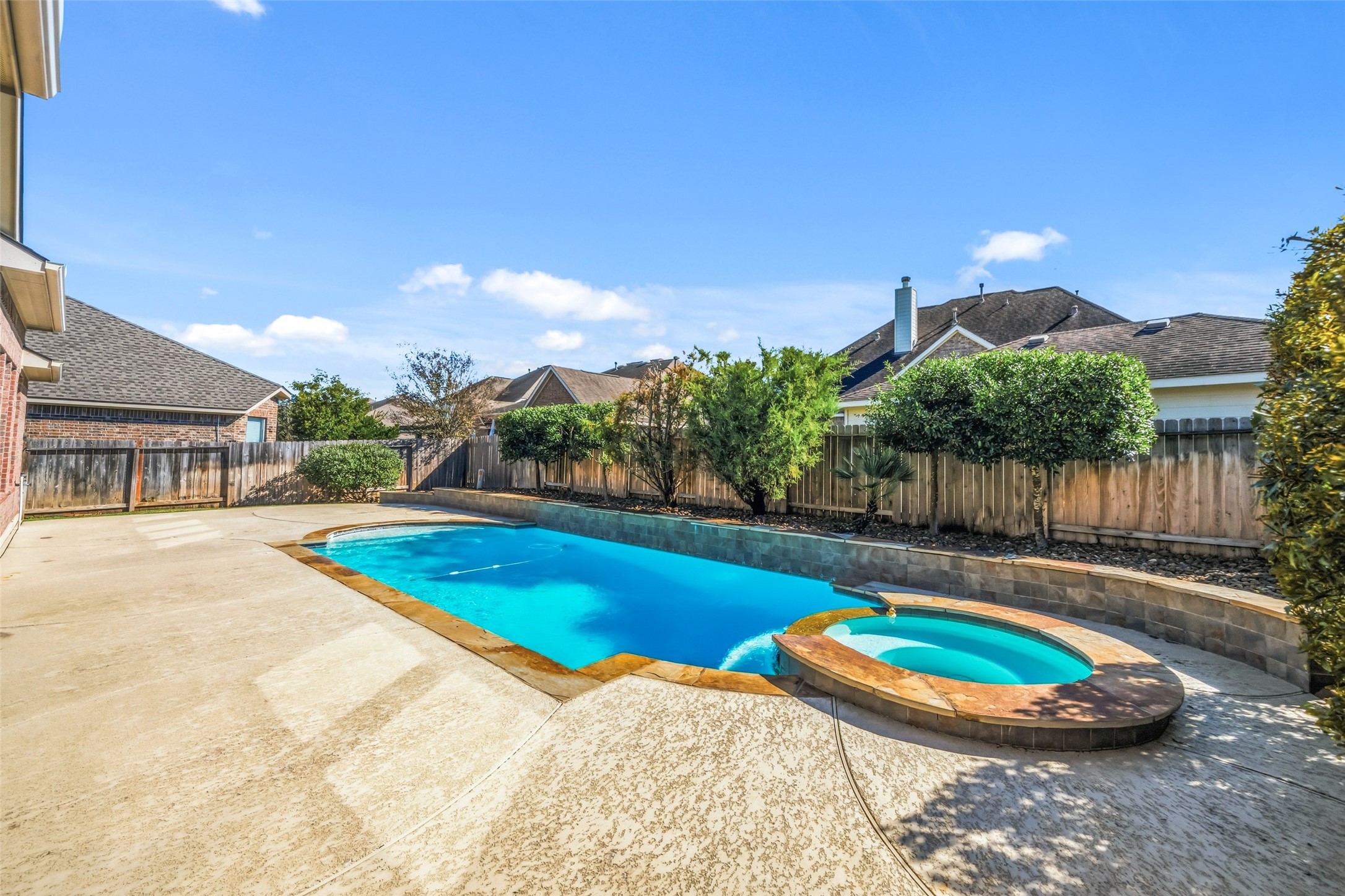 25802 Northcrest Drive Spring, TX 77389 - Photo 27 of 28 a view of a swimming pool with an outdoor space and seating area