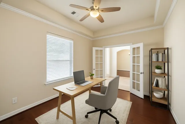a view of a workspace with furniture and a window
