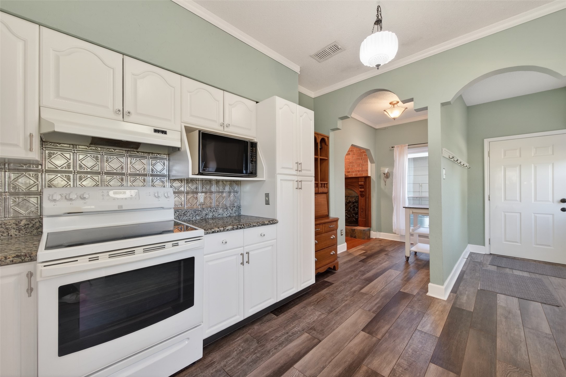 6610 Sprigg Street Fulshear, TX 77441 - Photo 11 of 41 a kitchen with stainless steel appliances a stove microwave and cabinets