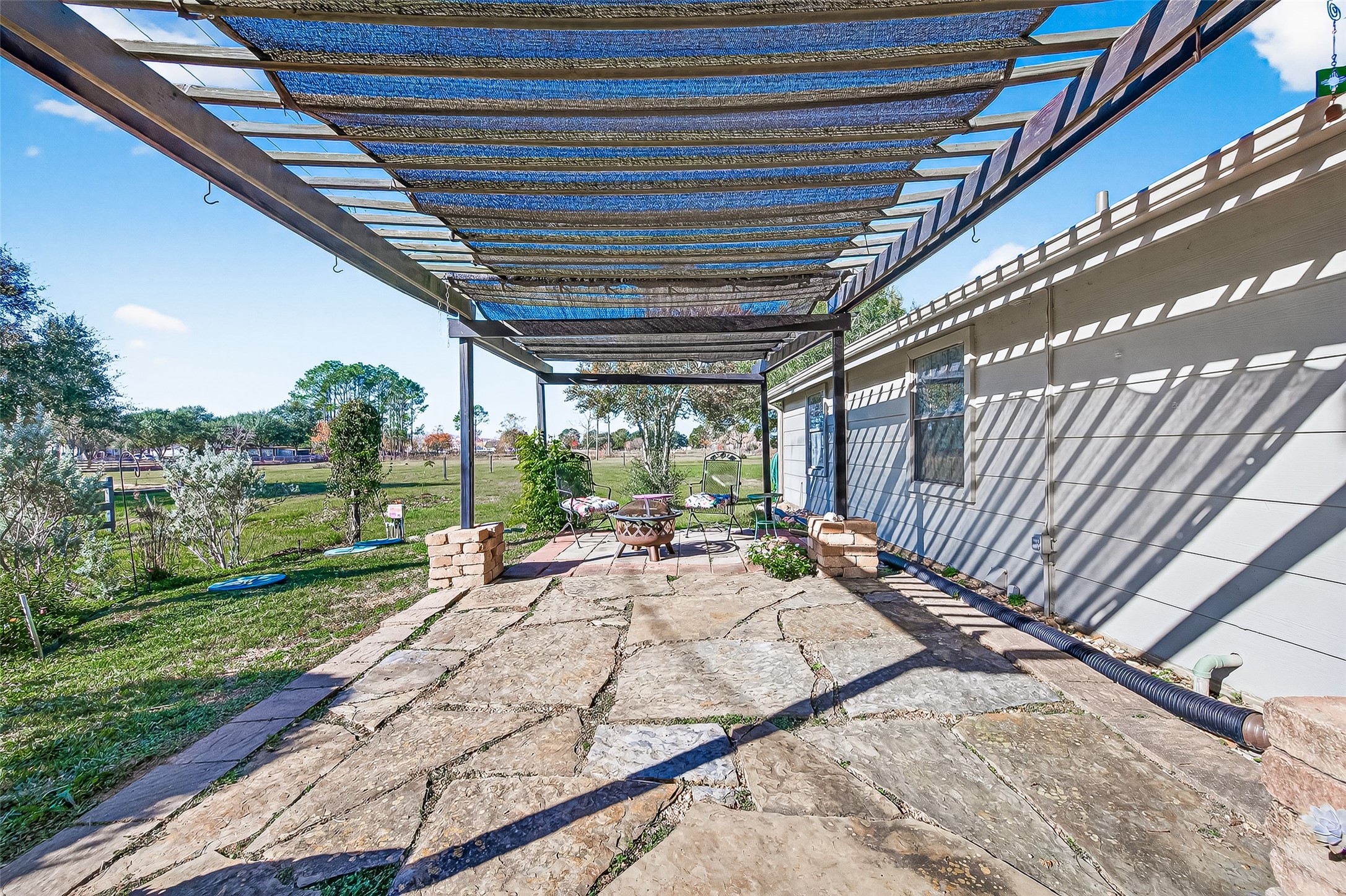 6610 Sprigg Street Fulshear, TX 77441 - Photo 28 of 41 a view of a backyard with sitting area