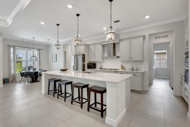 a large kitchen with kitchen island a sink a counter space and living room view