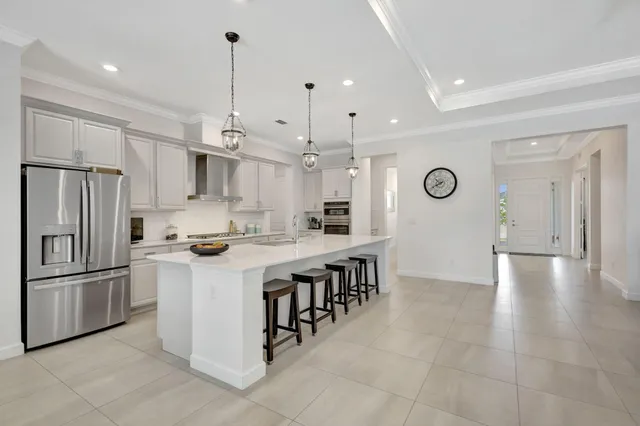 a kitchen with stainless steel appliances granite countertop a sink stove and cabinets