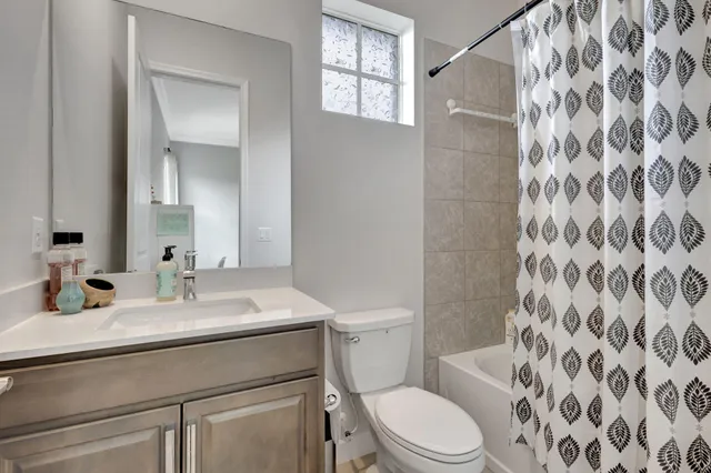 a front view of a house with a yard and potted plants
