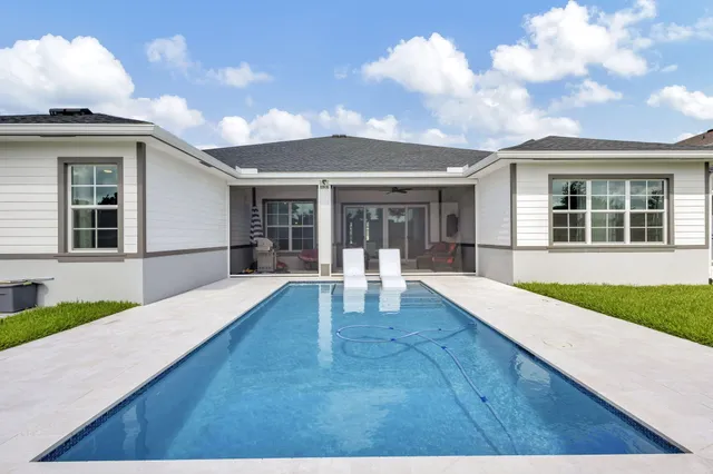 a view of a patio with table and chairs with wooden floor and fence