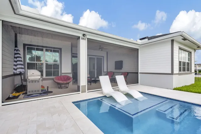 a living room with furniture gym equipment and a large window