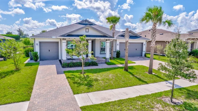 a view of a park with a house in the background