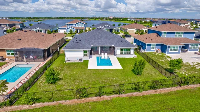 an aerial view of a house with a lake view