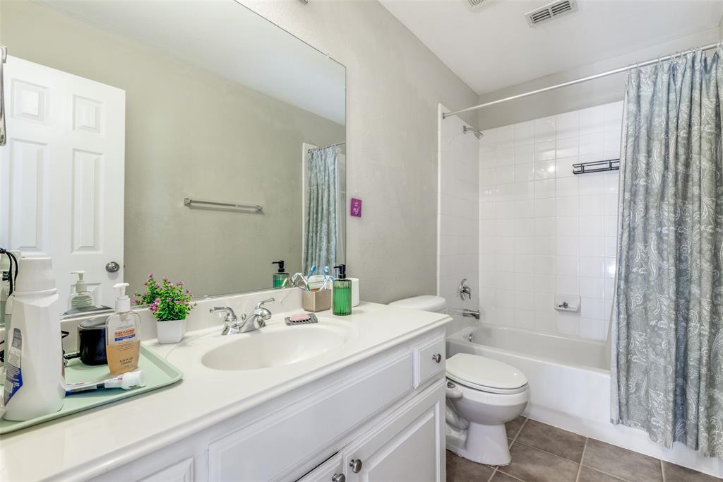 14886 Daneway Drive Frisco, TX 75035 - Photo 18 of 30 a bathroom with a sink a toilet and shower