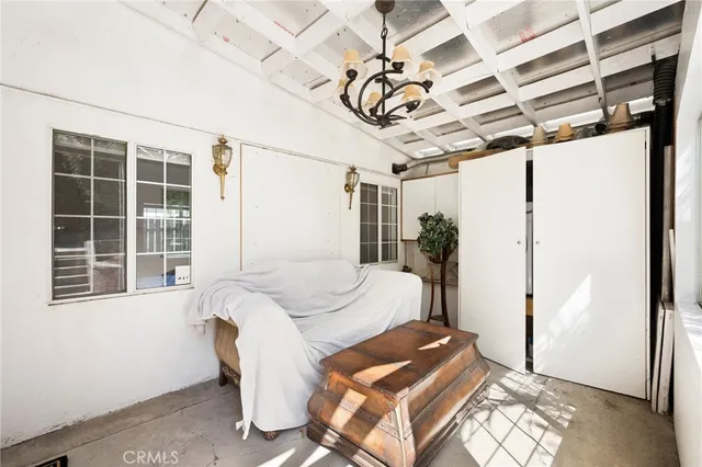 a bedroom with furniture and a window