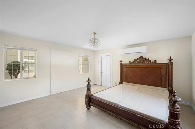 a bedroom with a bed and dresser with mirror