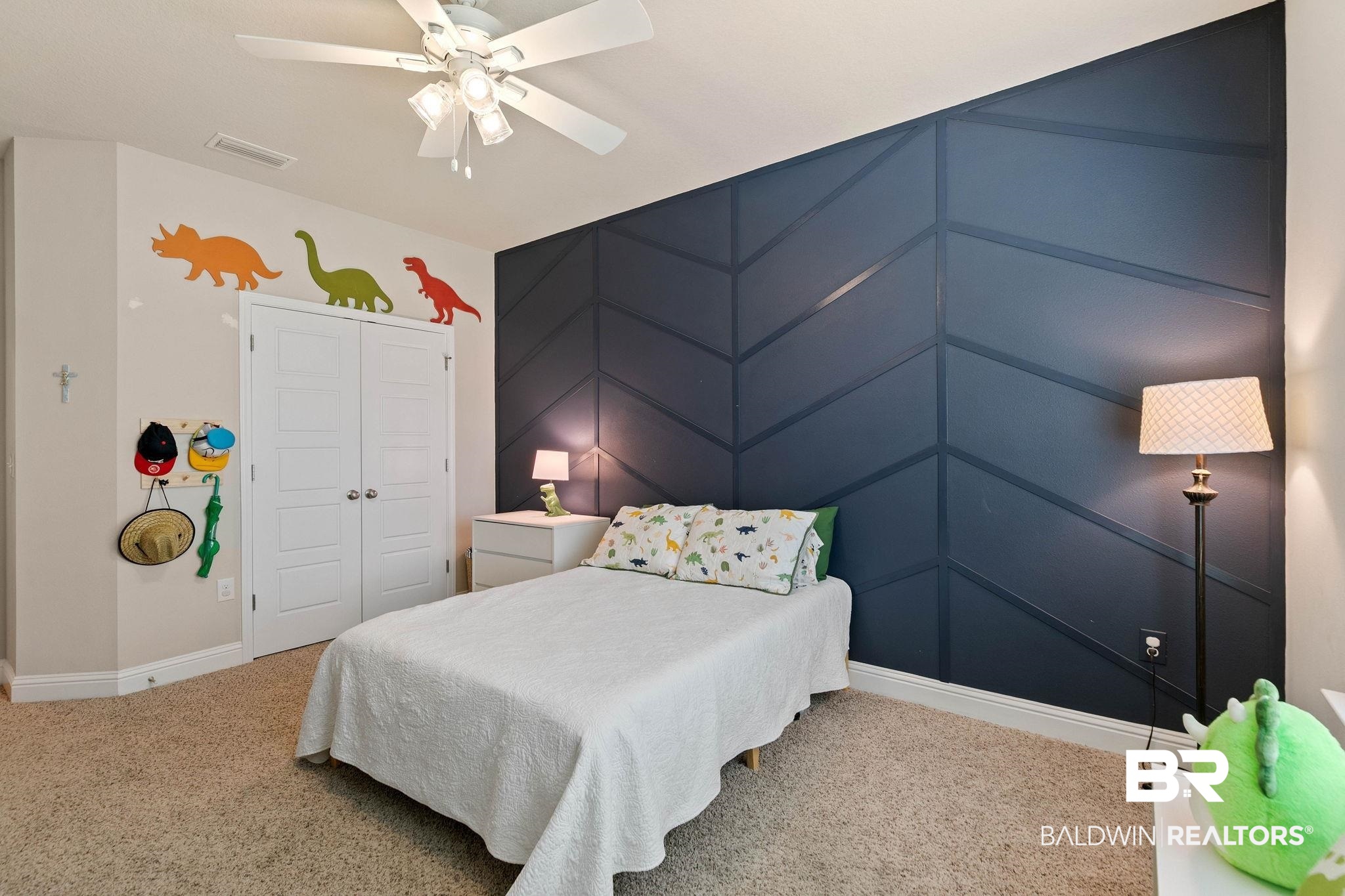 12750 B Jenkins Pit Road Daphne, AL 36527 - Photo 47 of 89 Carpeted bedroom featuring a closet, an accent wall, a ceiling fan, and a decorative wall