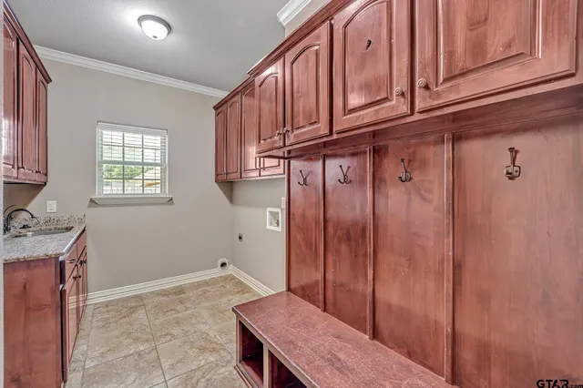 a view of a kitchen with granite countertop wooden cabinets