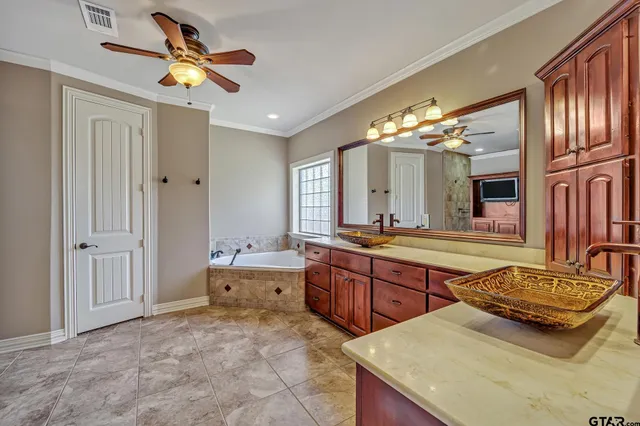 a spacious bathroom with a granite countertop sink and a mirror
