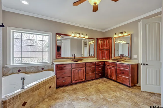 a large bathroom with a large tub sink and mirror
