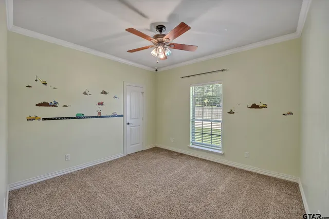 a view of an empty room with a ceiling fan