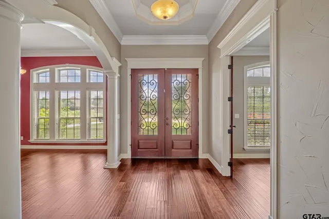 a view of an entryway with wooden floor and windows