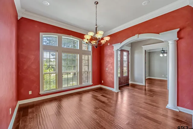 a view of a room with window wooden floor and chandelier