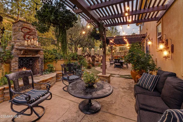 a building outdoor space with patio furniture and a fireplace