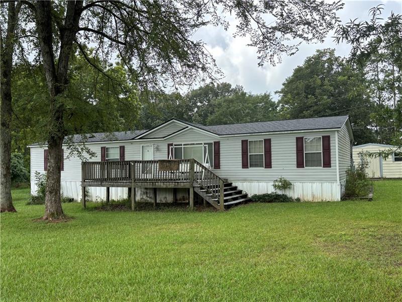 21 Hubbard Lane Lexington, GA 30648 - Photo 1 of 1 a front view of a house with a garden and deck