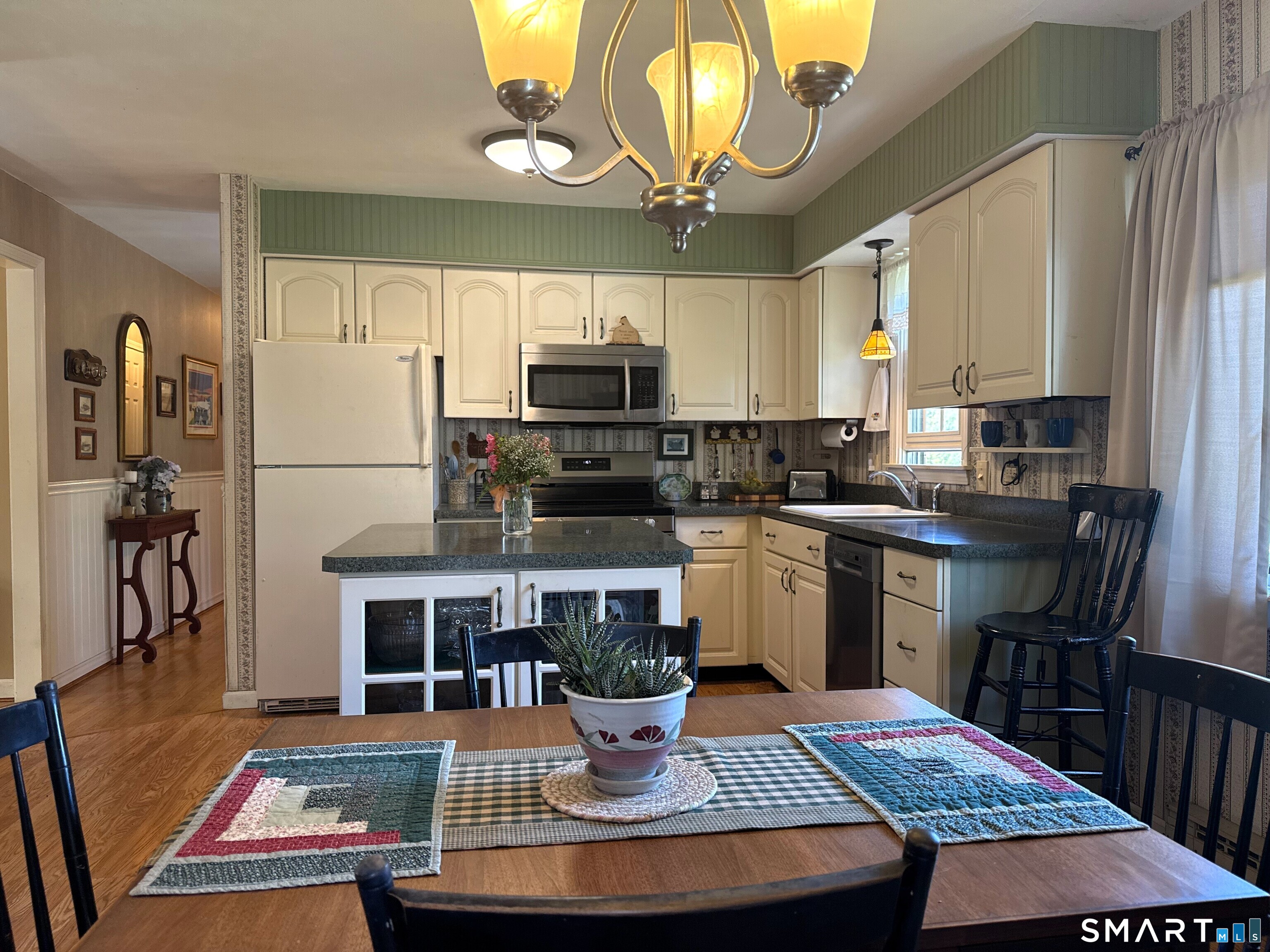 15 Grove Street Deep River, CT 06417 - Photo 5 of 25 a kitchen with a appliances cabinets a dining table and chairs