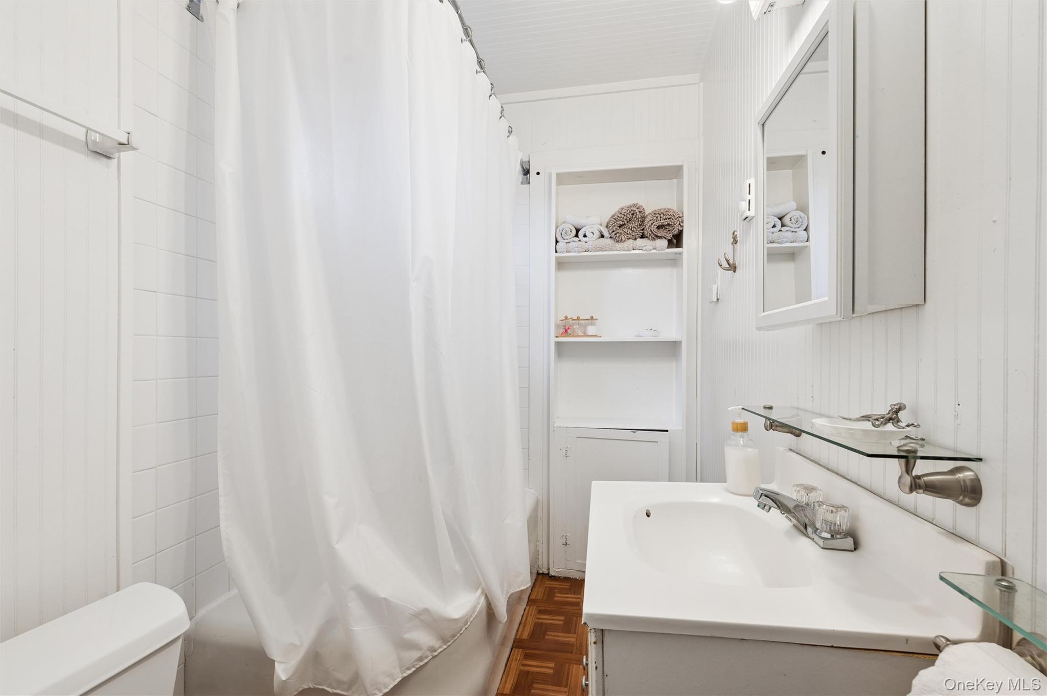 6 Private Row Hampton Bays, NY 11946 - Photo 11 of 14 a bathroom with a sink a toilet and shower curtain