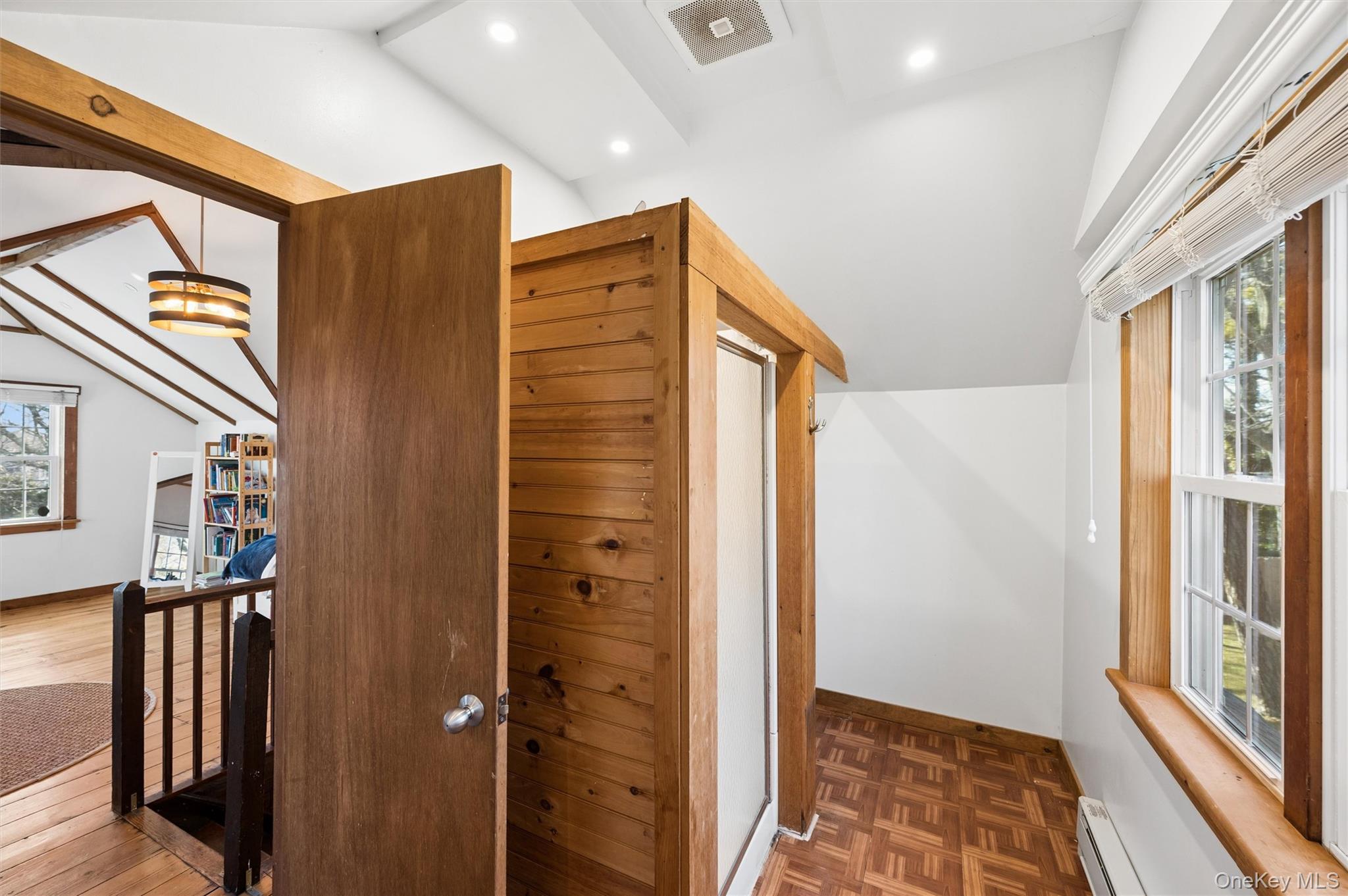 6 Private Row Hampton Bays, NY 11946 - Photo 13 of 14 a view of hallway with a large window and wooden floor