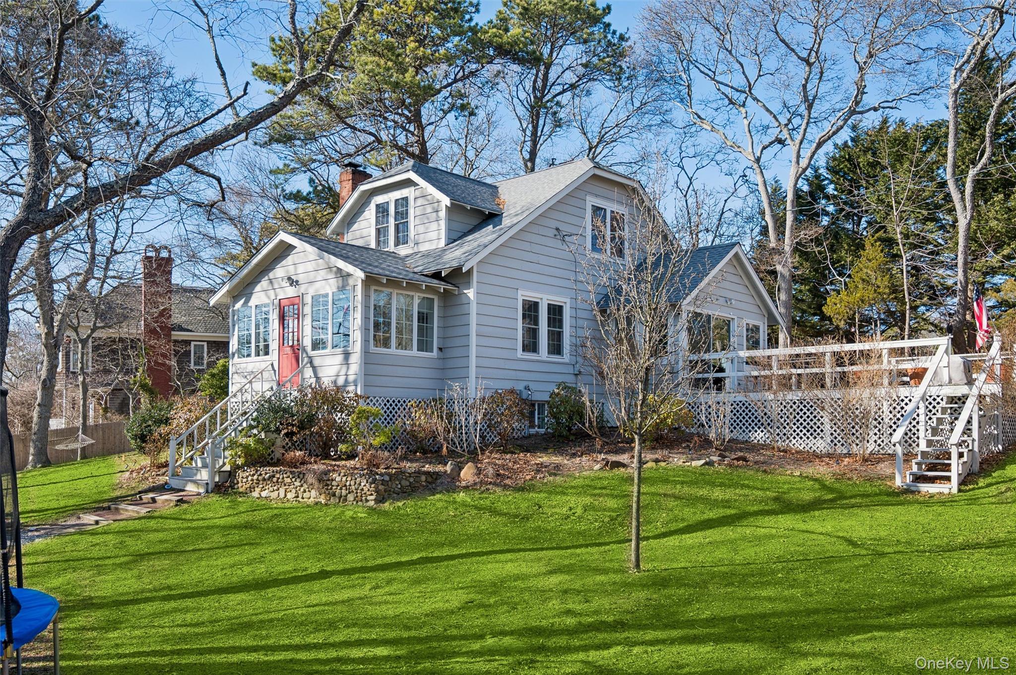 6 Private Row Hampton Bays, NY 11946 - Photo 2 of 14 a front view of a house with a yard