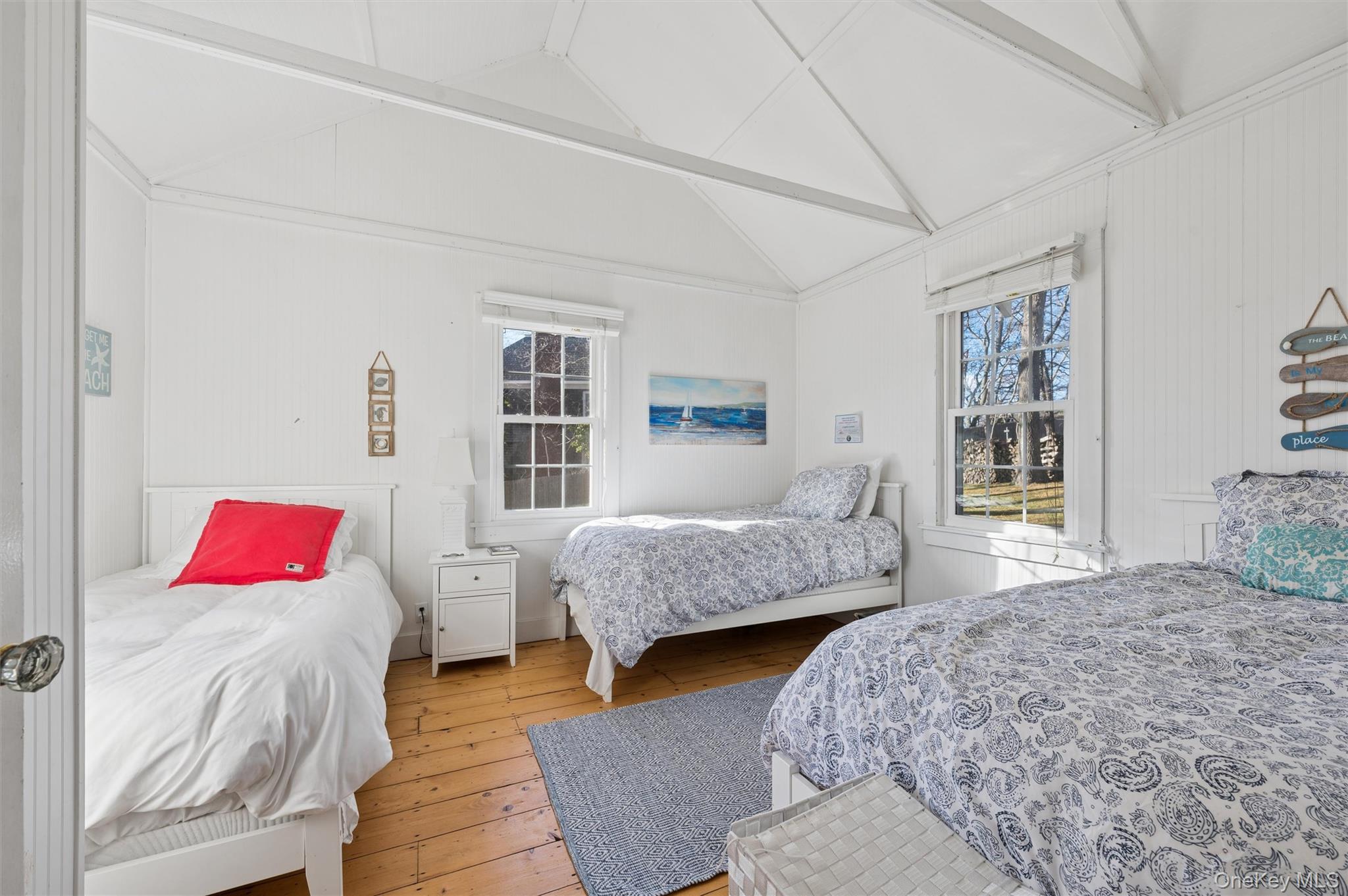 6 Private Row Hampton Bays, NY 11946 - Photo 9 of 14 a bedroom with a bed and wooden floor