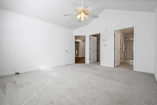 a view of a big room with chandelier fan