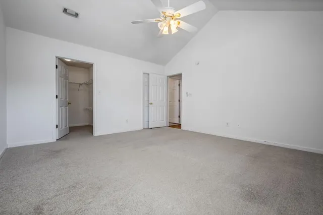a view of a chandelier fan and fire place