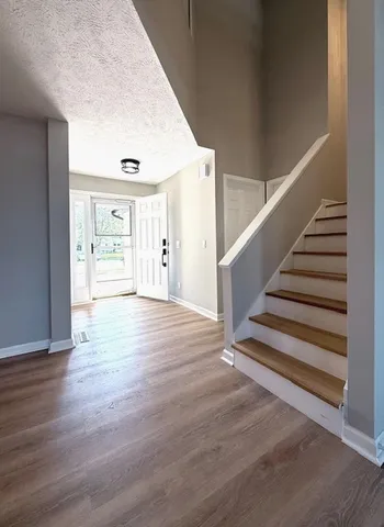 an empty room with closet and windows