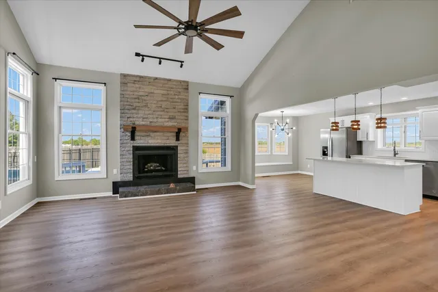 a view of an empty room with wooden floor and closet area