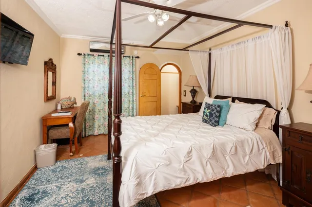 a bedroom with a large bed and a chandelier