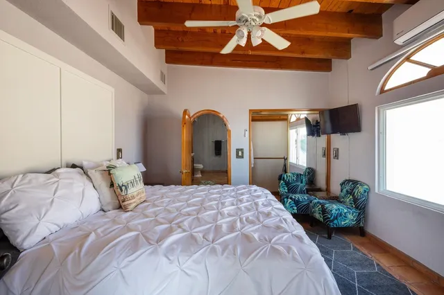 a bedroom with a bed and a window