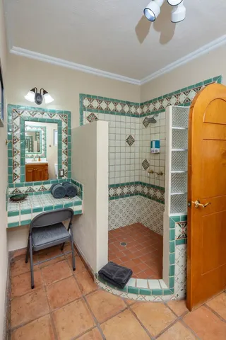 a bathroom with a granite countertop sink a toilet and a mirror
